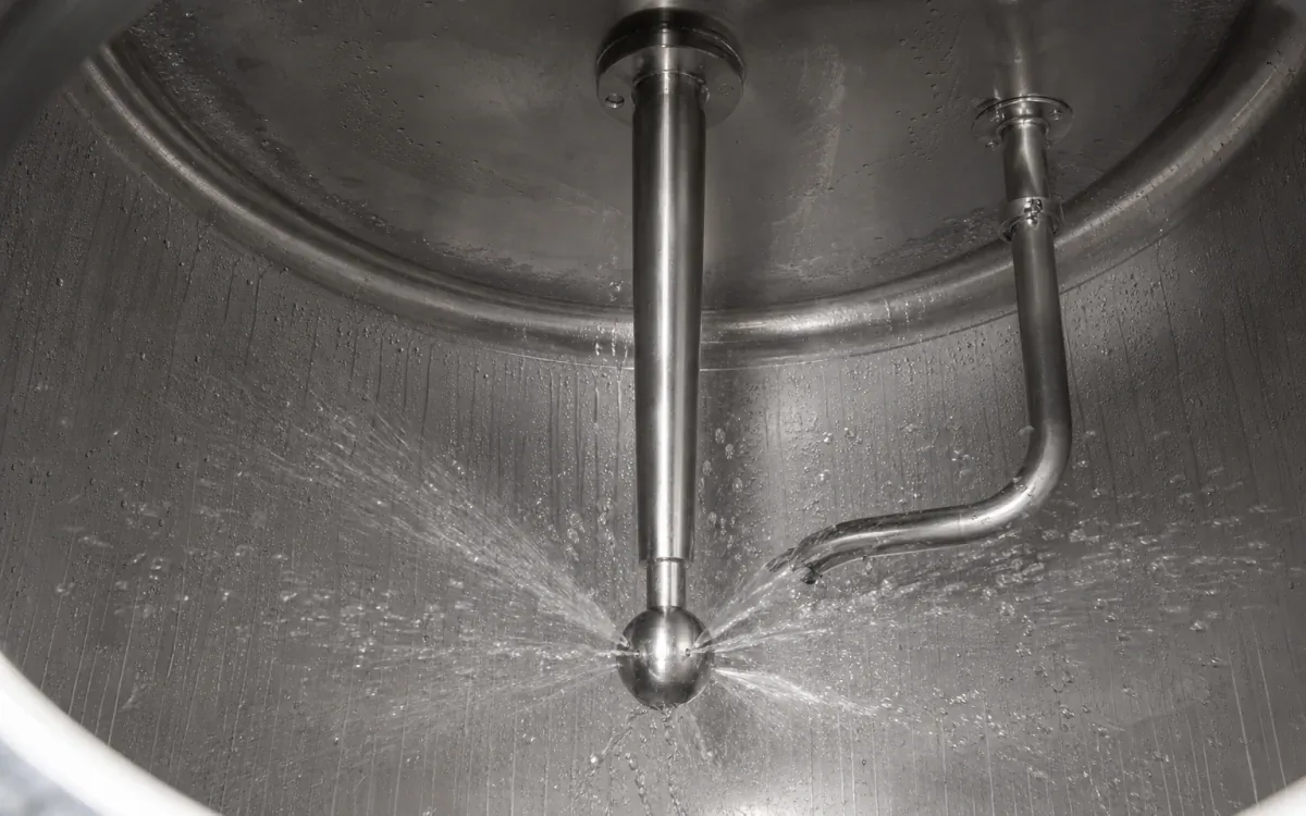 Clean-in-place spray ball rinsing the interior of a stainless beverage process tank
